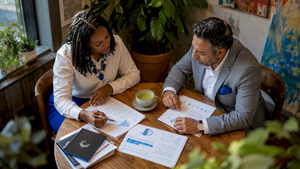 Recruiter and manager reviewing sales candidate resumes