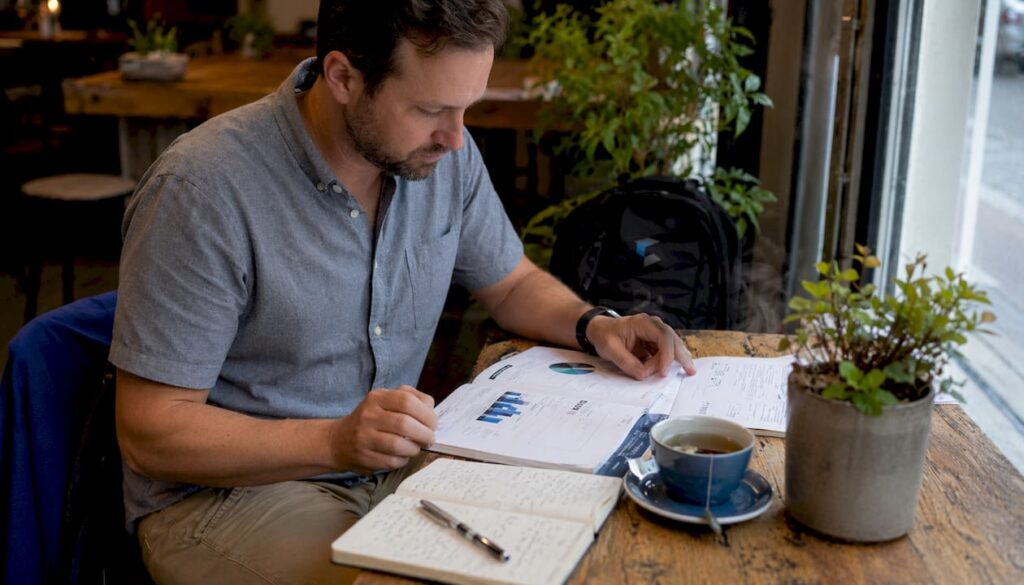 Founder reviewing sales recruitment guide at desk