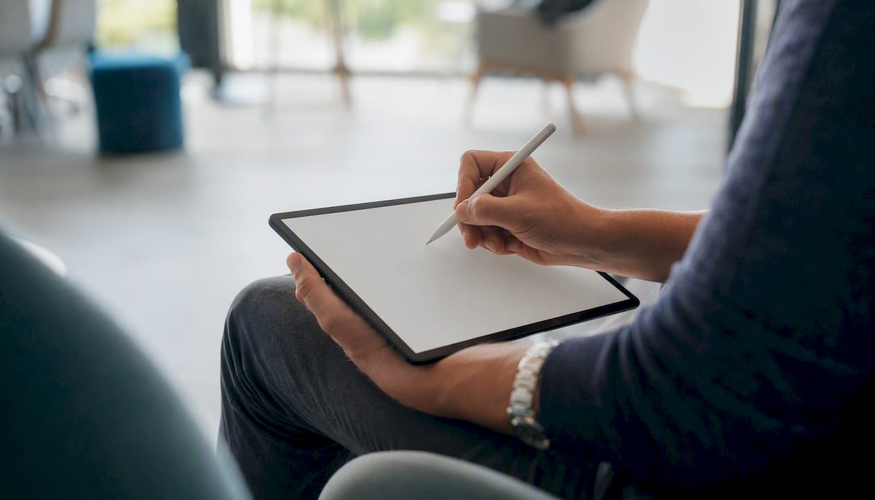 Founder hand taking notes on tablet during BDR interview