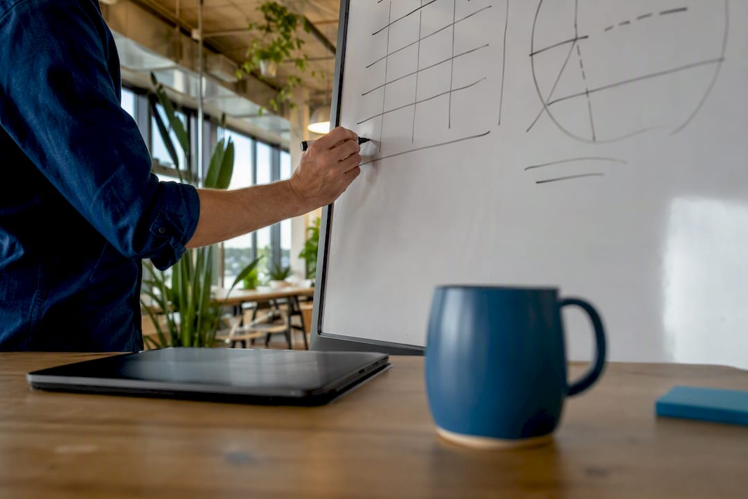 Hands calculating equity cap table on desk