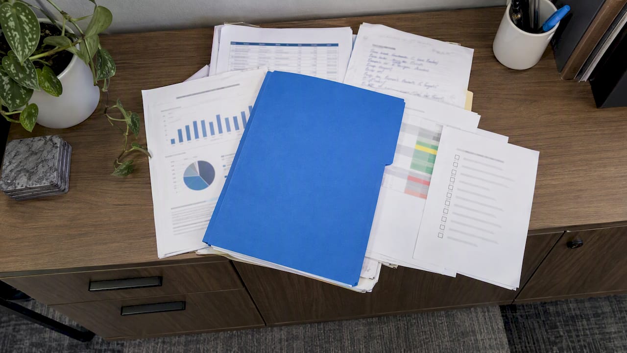Sales leadership handover materials on a credenza