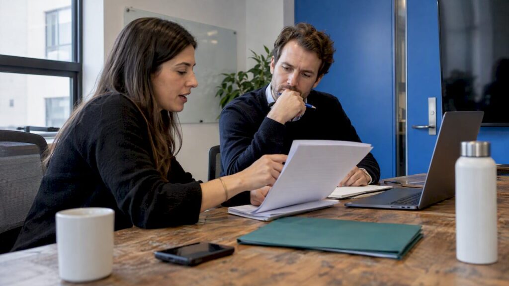 Founder and candidate reviewing a sales work sample